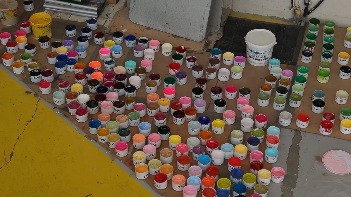 Hundreds of ink pots on a print floor, from directly above